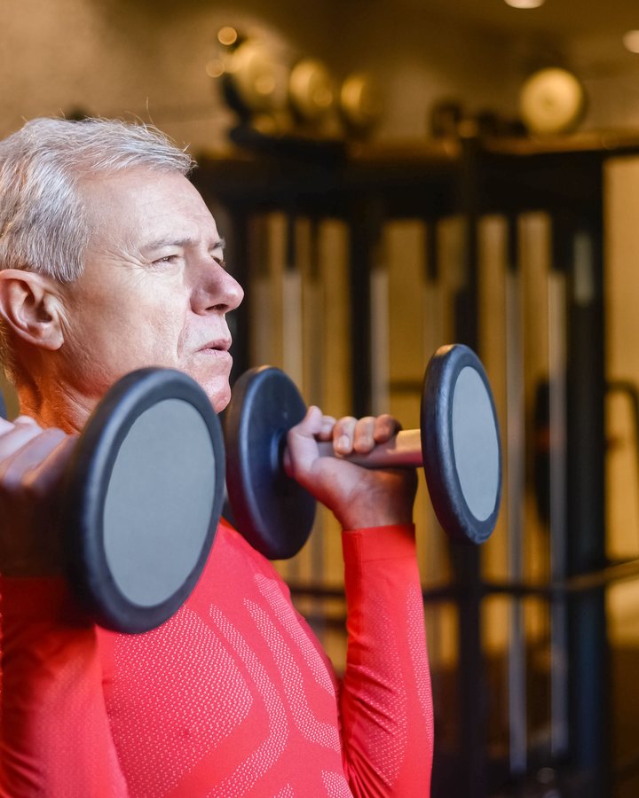 Demo stock image of the same older man lifting dumbbells
